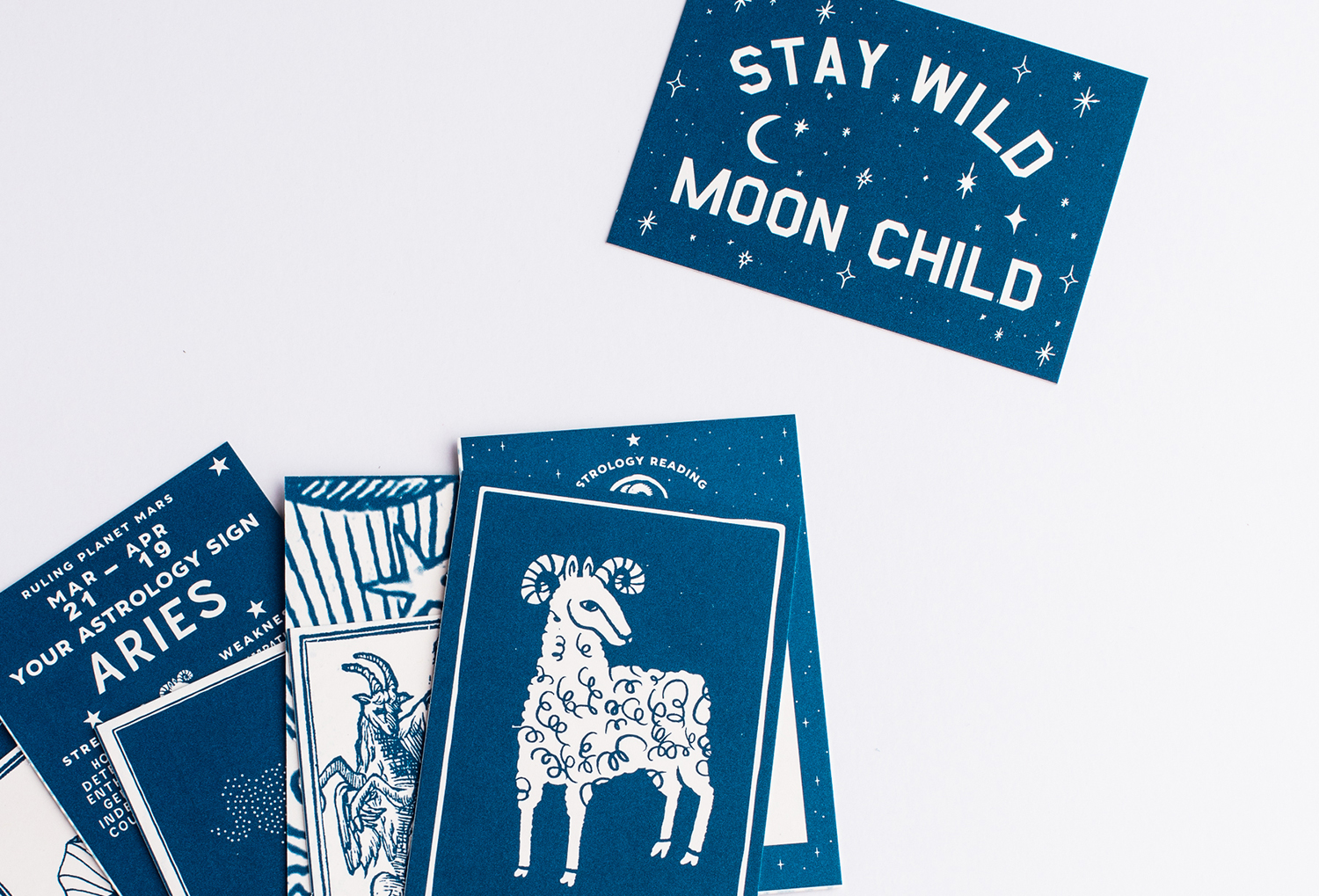 Astrology cards that show an Aries sign and one that says "Stay Wild Moon Child"