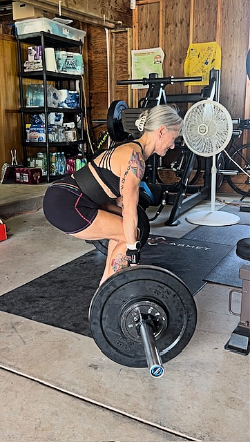 Silver and Strong Ilene Block lifting heavy weights in the gym, which she does five days each week. 