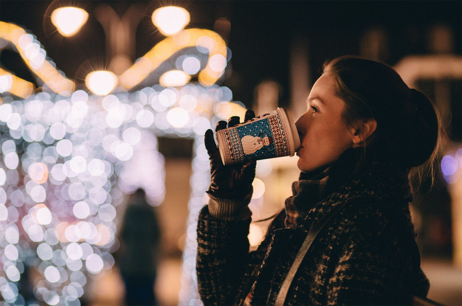 holiday lights woman drinking coffee