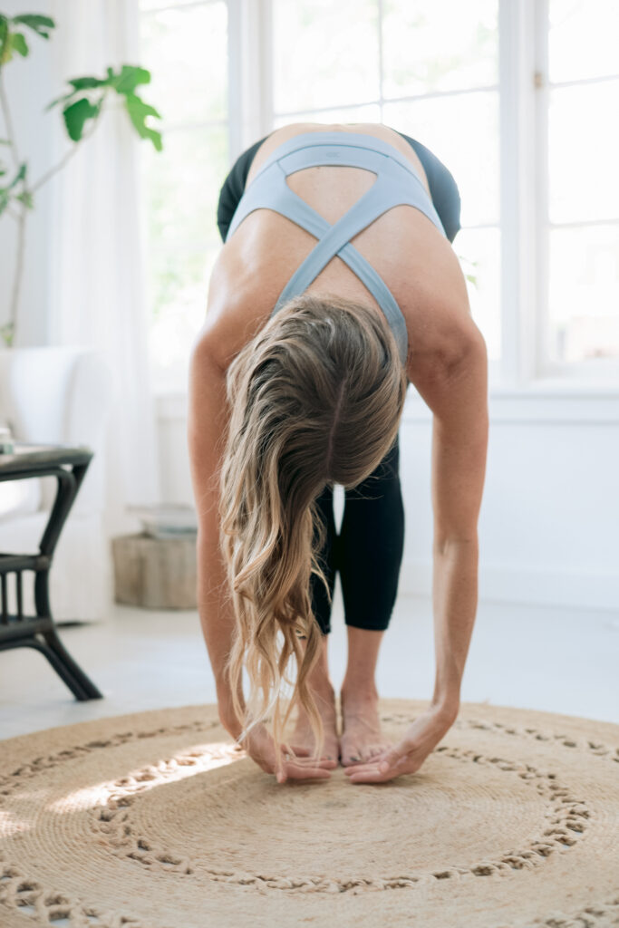 Woman bending at waist in yoga pose