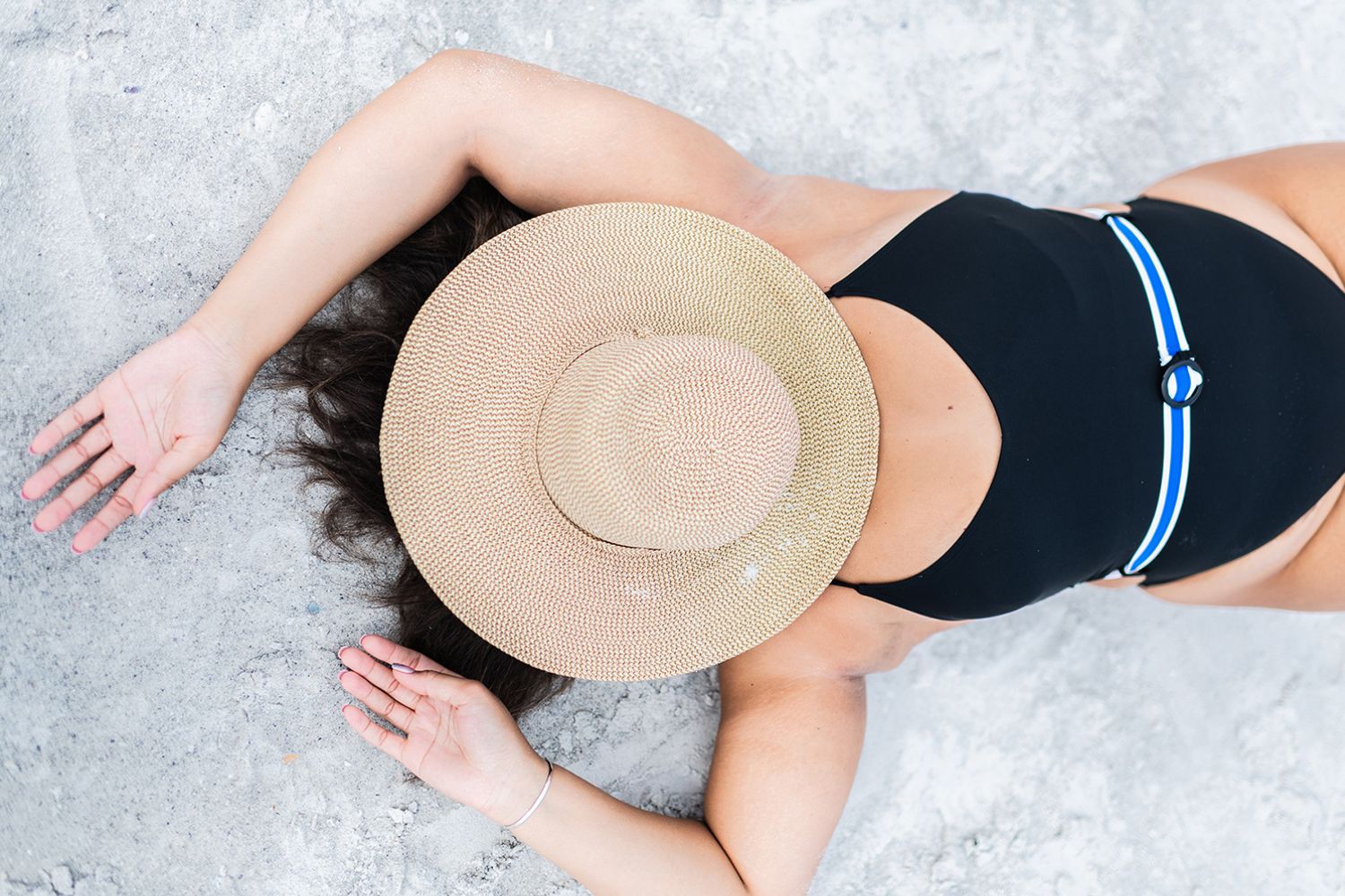 Woman on beach wearing hat