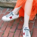 woman in orange-red skirt with sneakers