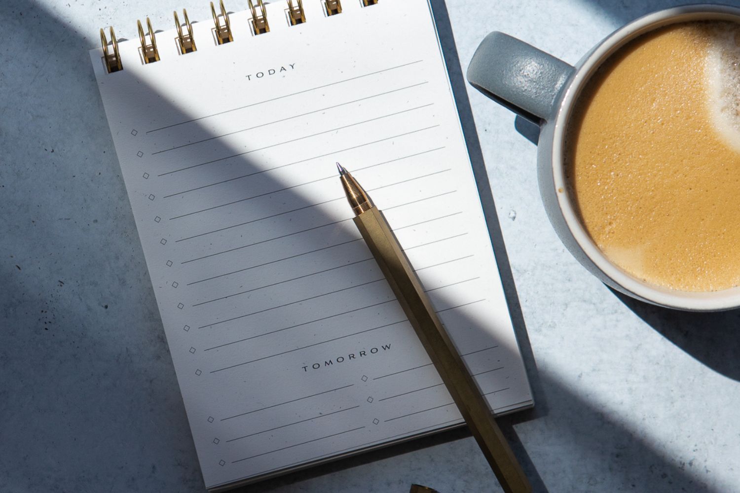 notepad, pencil, and coffee