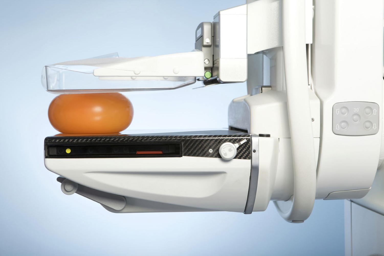 mammogram machine smooshing orange ball
