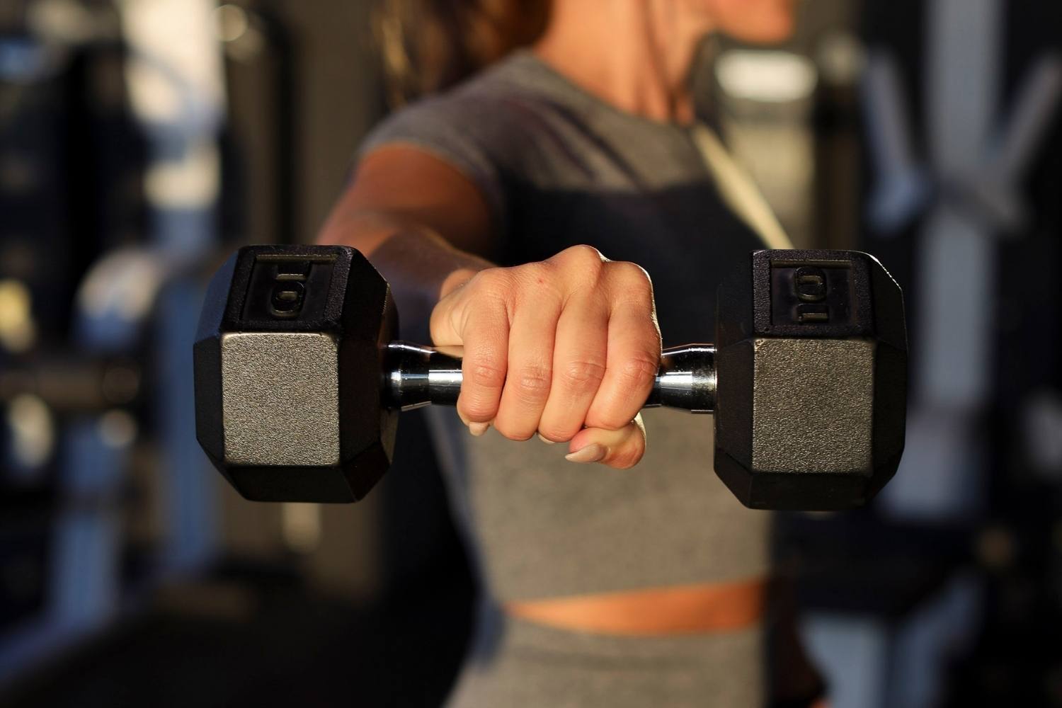 woman holding dumbbell