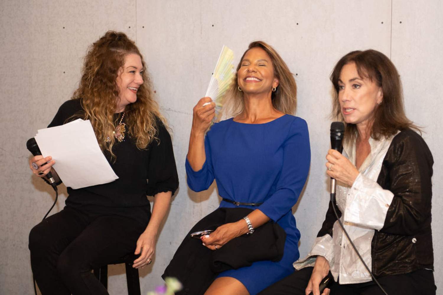 Rachel Hughes fanning herself, next to Amy Cuevas Schroeder and Dr. Lauren Streicher