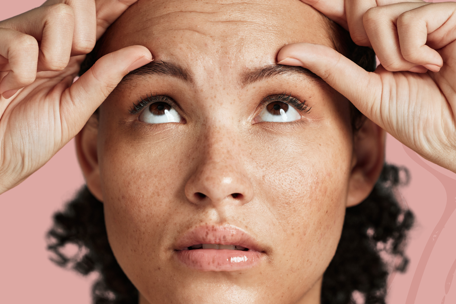 woman holding forehead with both hands, wrinkles shown, thinking