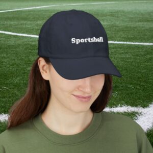 Woman wearing a navy cap that says "Sportsball"