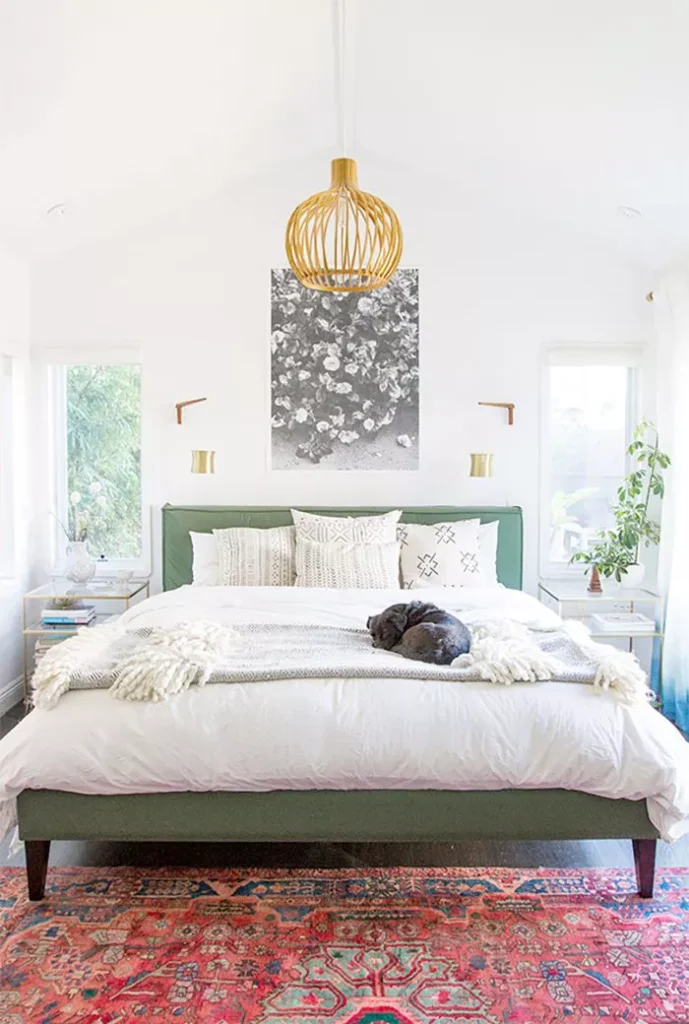 Feng shui bedroom with white walls, red carpet, and green bedframe