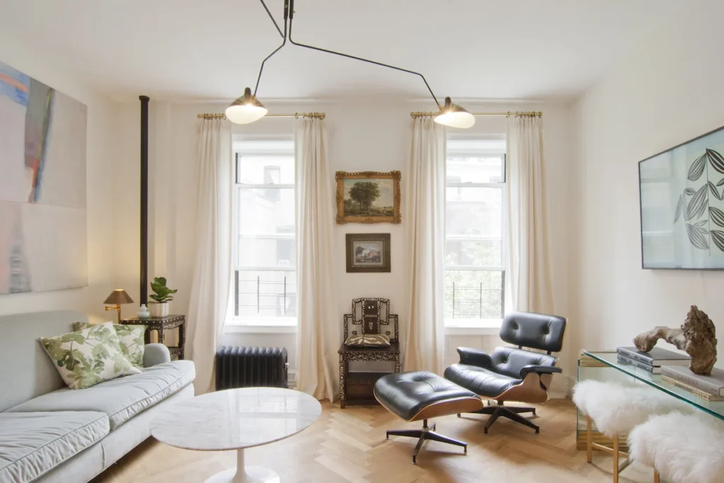 Feng shui living room was designed by Anjie Cho. Includes an Eames chair and round coffee table.