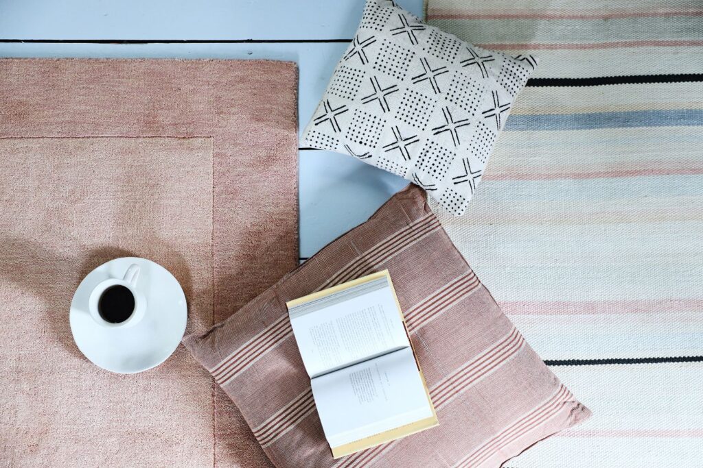 pink rug, white and pink striped rug, and pink floor pillow
