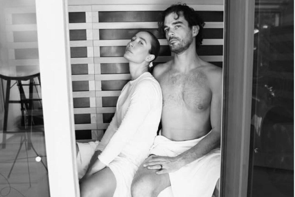 Kayla Barnes and her partner sitting in a home sauna