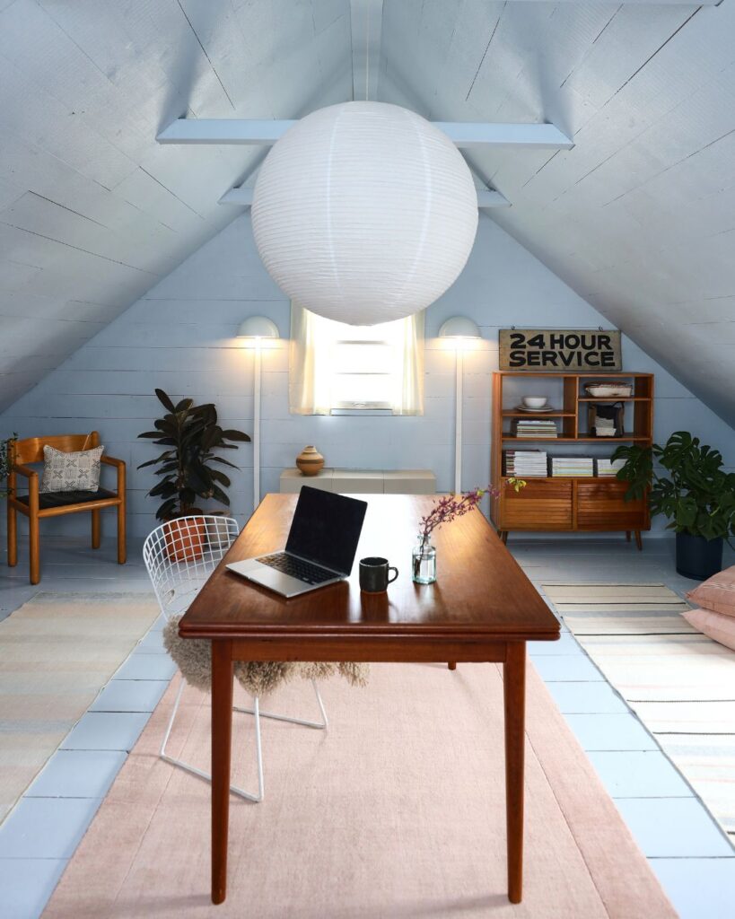 Midcentury modern desk and white chair in a light-blue home office