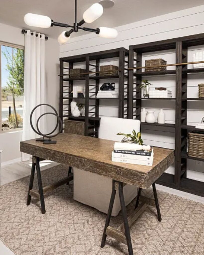 Pulte model home office with staged decorating in San Tan Valley, Arizona. White shiplap walls, bookshelves, and a wood desk.