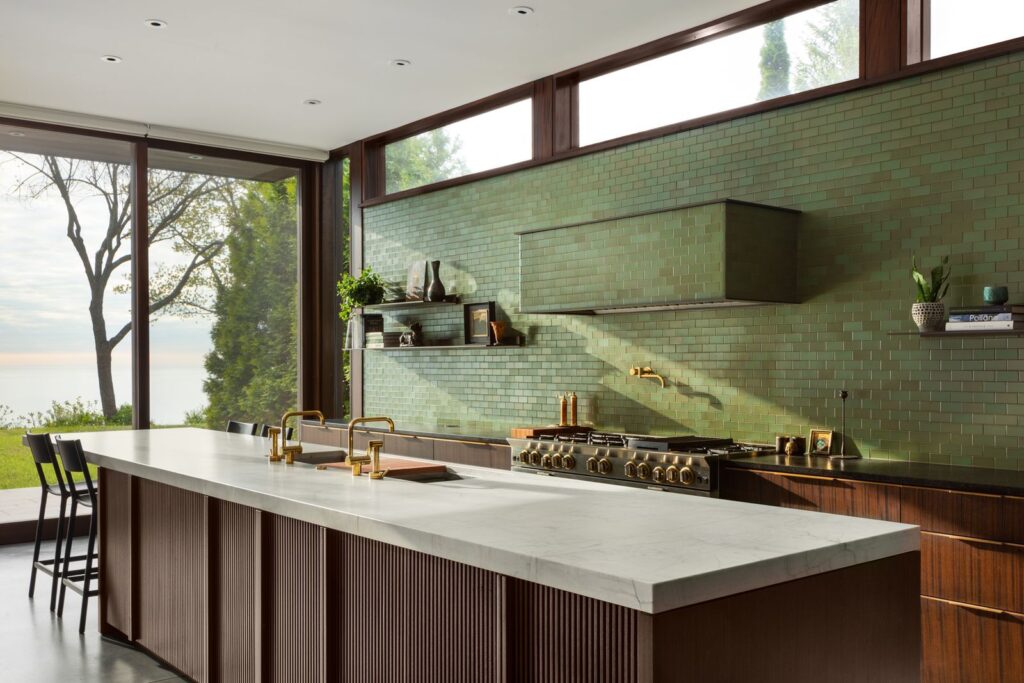 A clean kitchen with green tile backsplash
