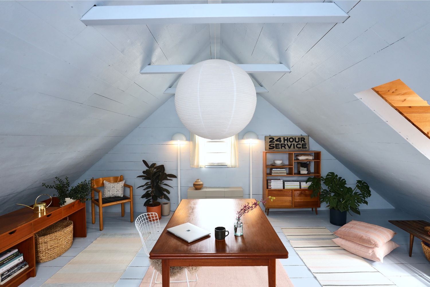 light blue loft space with midcentury furniture and white Chinese lantern