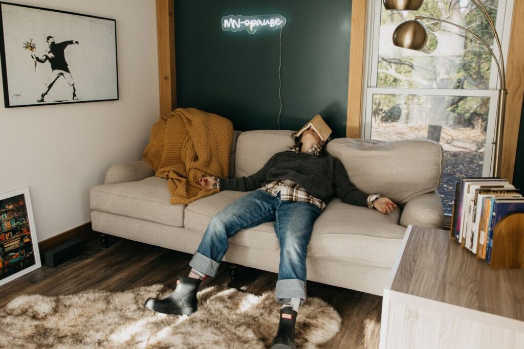 a photo of Sara Larson sitting on a couch with a book on her head.