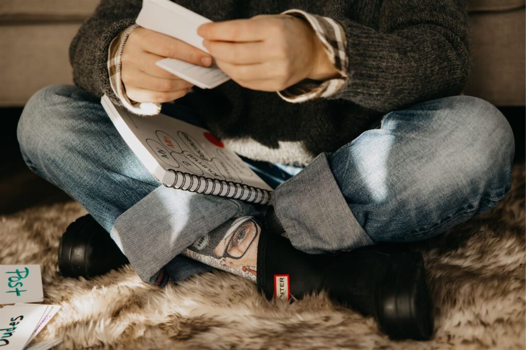 Menopause coach Sara Larson sitting on the floor with her legs crossed