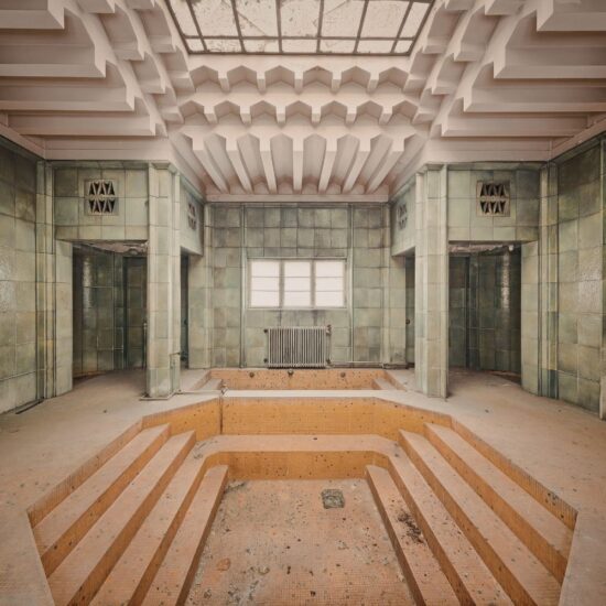 abandoned indoor pool room with no water