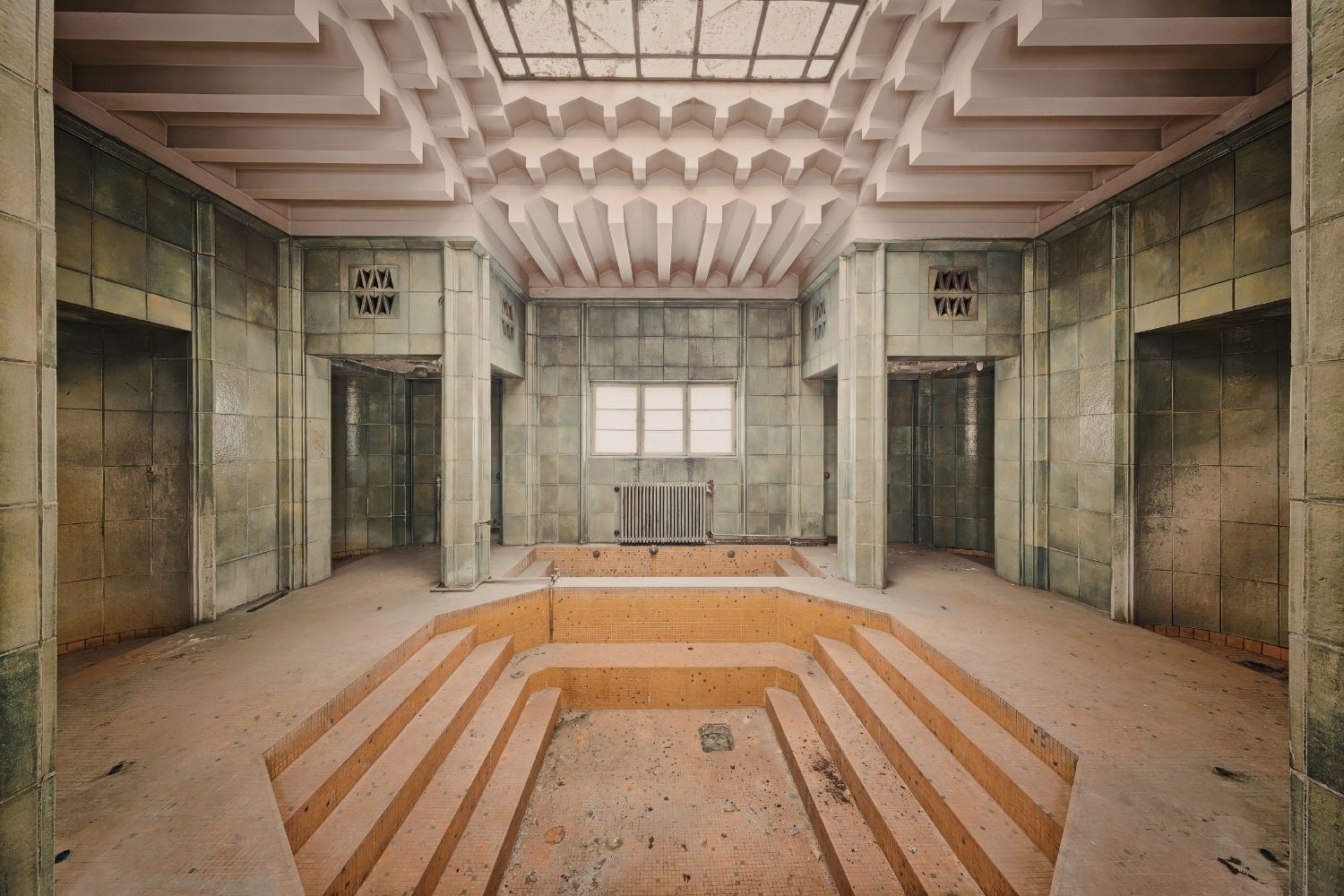 abandoned indoor pool room with no water