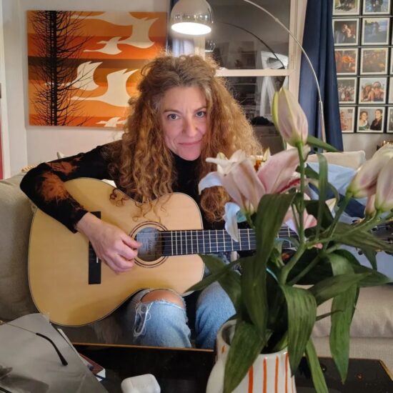 Amie Newman playing guitar