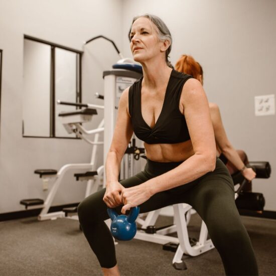Woman squatting with Kettlebell